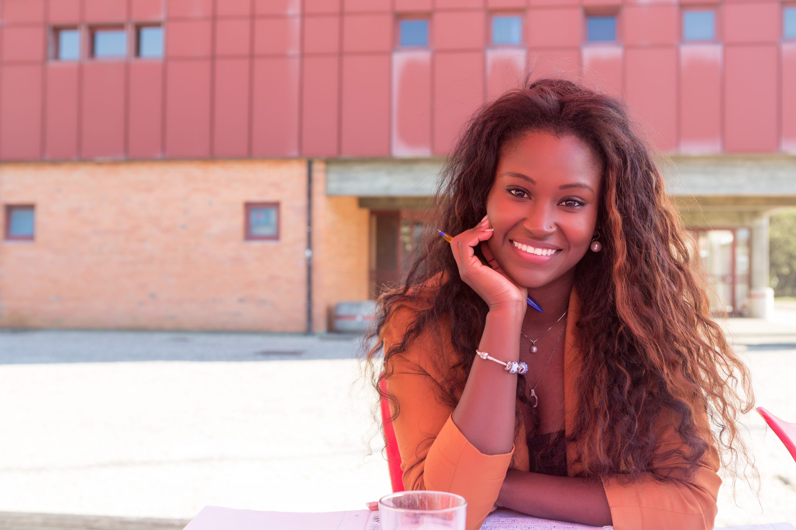 Young african student preparing her exams at a local cafeteria