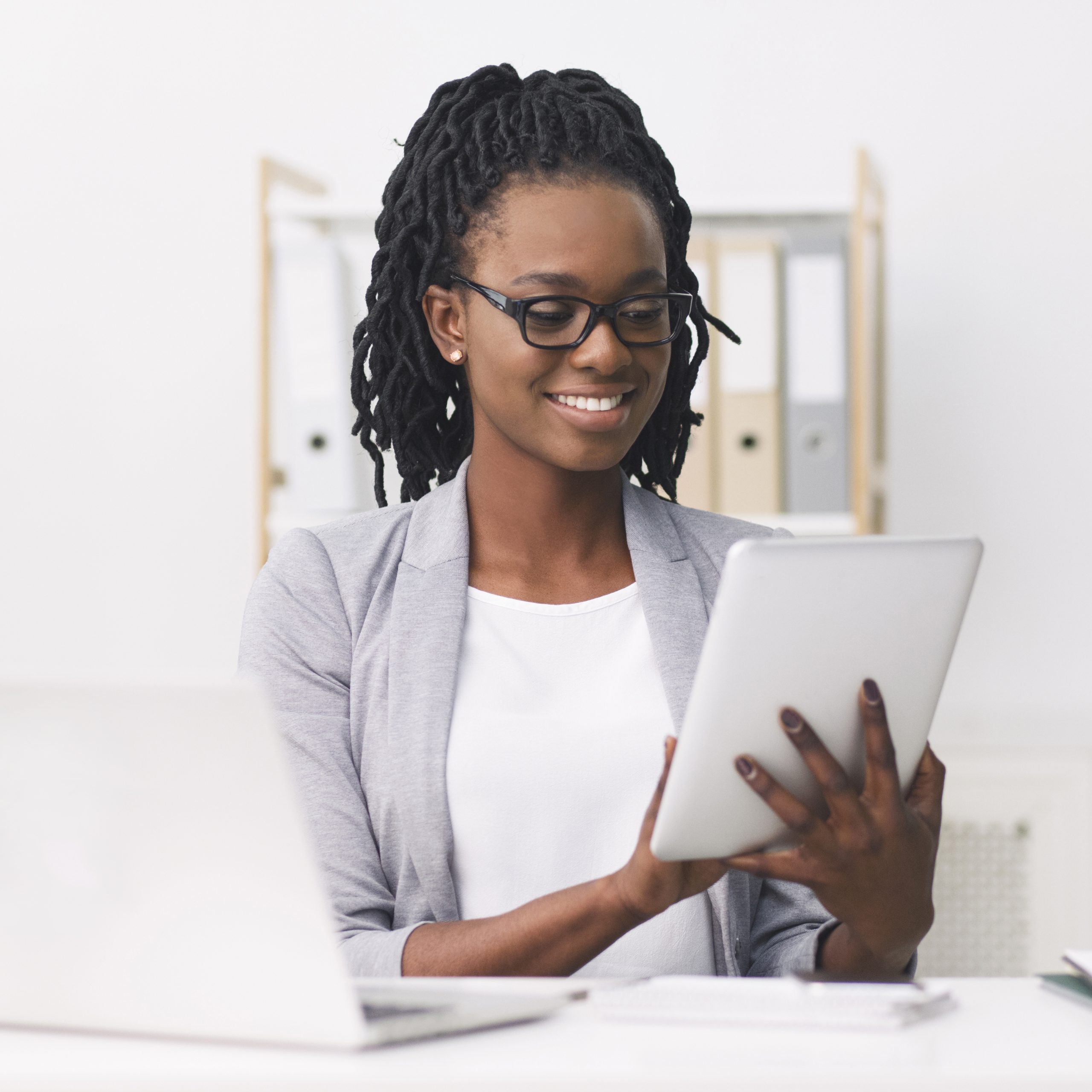 Business Apps. Afro Businesswoman Using Tablet And Laptop In Office.